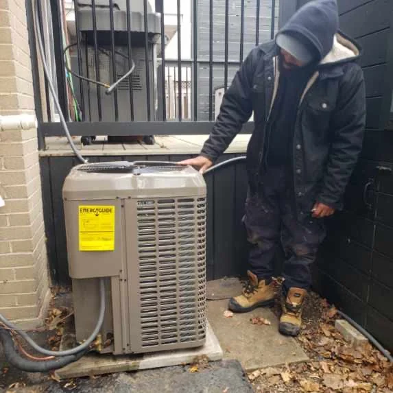 Rico's HVAC technician servicing an outdoor AC unit